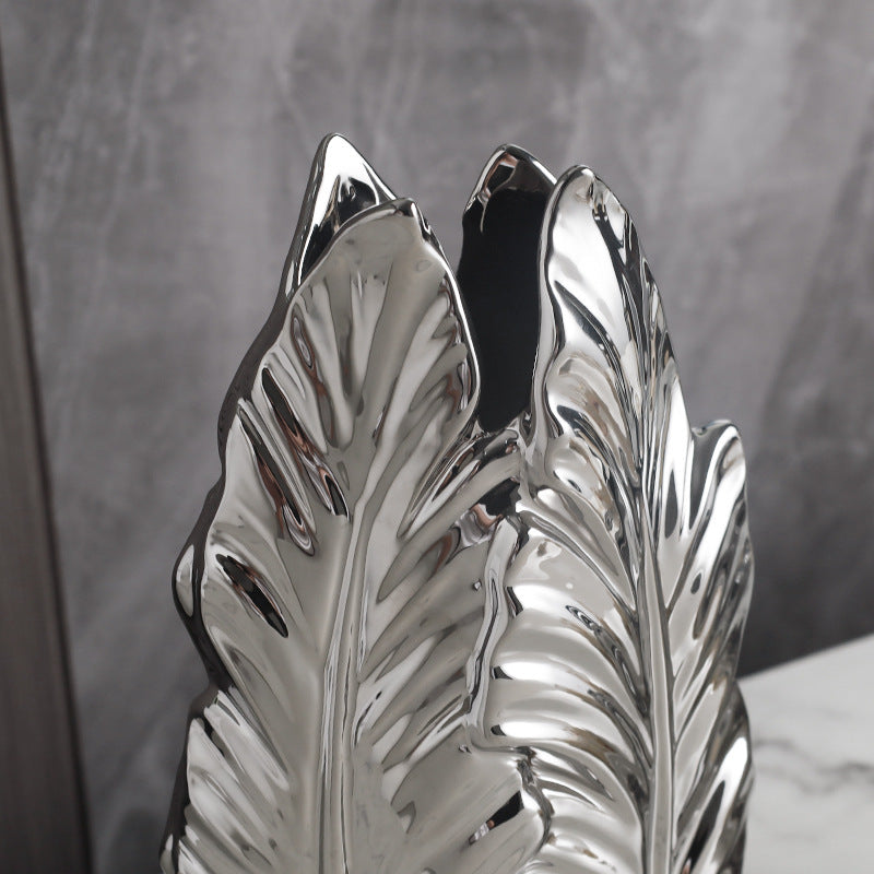 Close-up of a silver-plated leaf-shaped ceramic vase