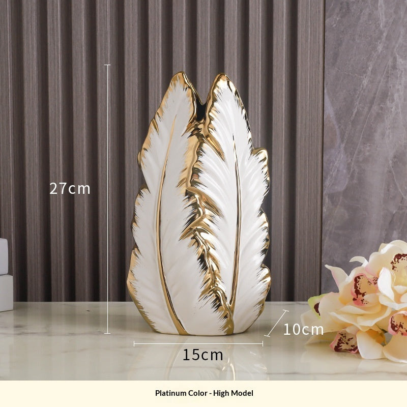 Tall white and gold leaf vase shown 27 cm high with a 15 × 10 cm base