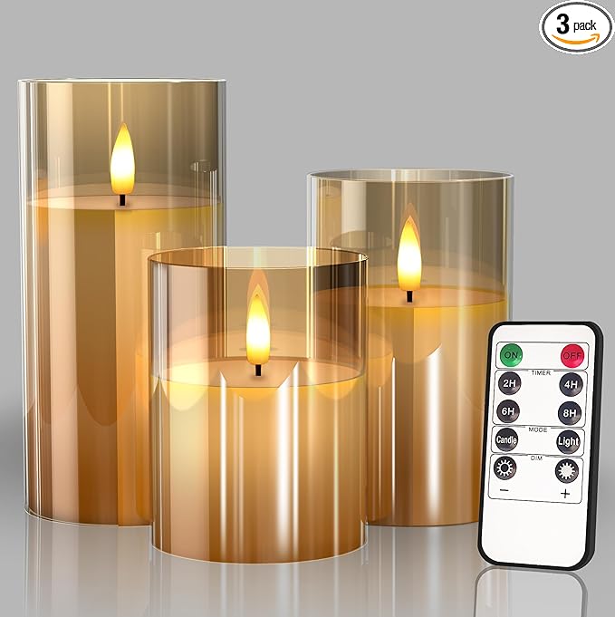 Set of three gold glass flameless LED candles in three heights with a remote control