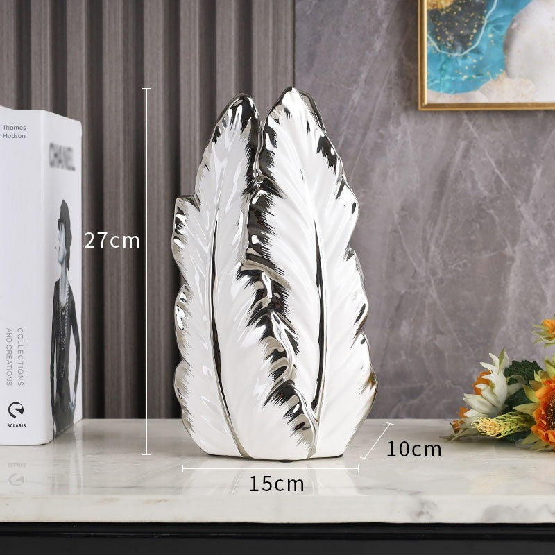 Tall white leaf-shaped ceramic vase with silver edges, 27 cm high