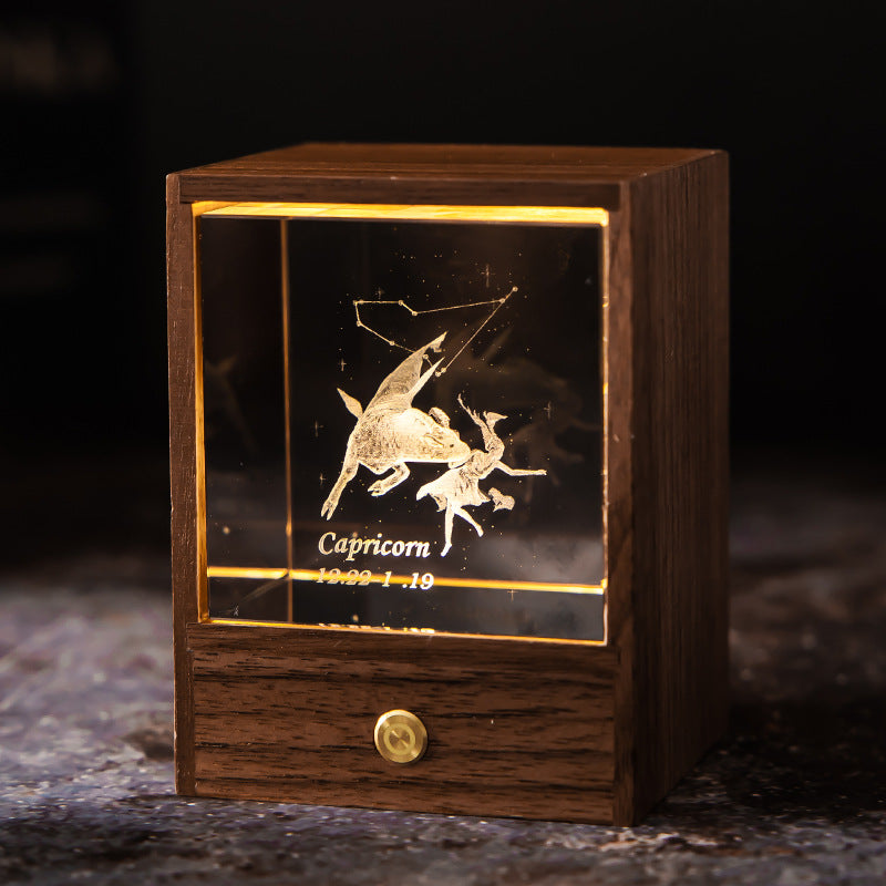 Lit Capricorn crystal night light with engraved figure and constellation in a walnut base