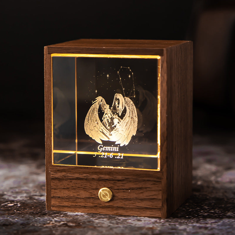 Lit Gemini crystal night light with engraved figure and constellation in a walnut base