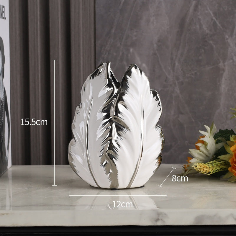 Short white leaf-shaped ceramic vase with silver edges, 15.5 cm high