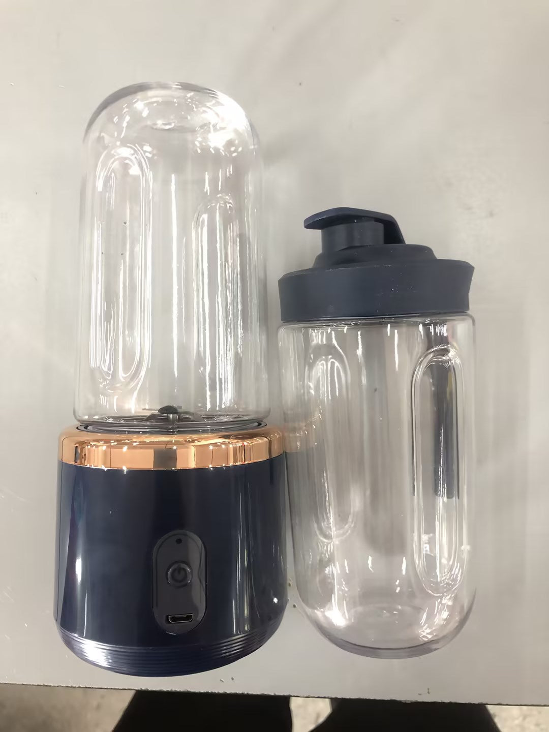 Navy portable blender with a clear jar and extra travel cup