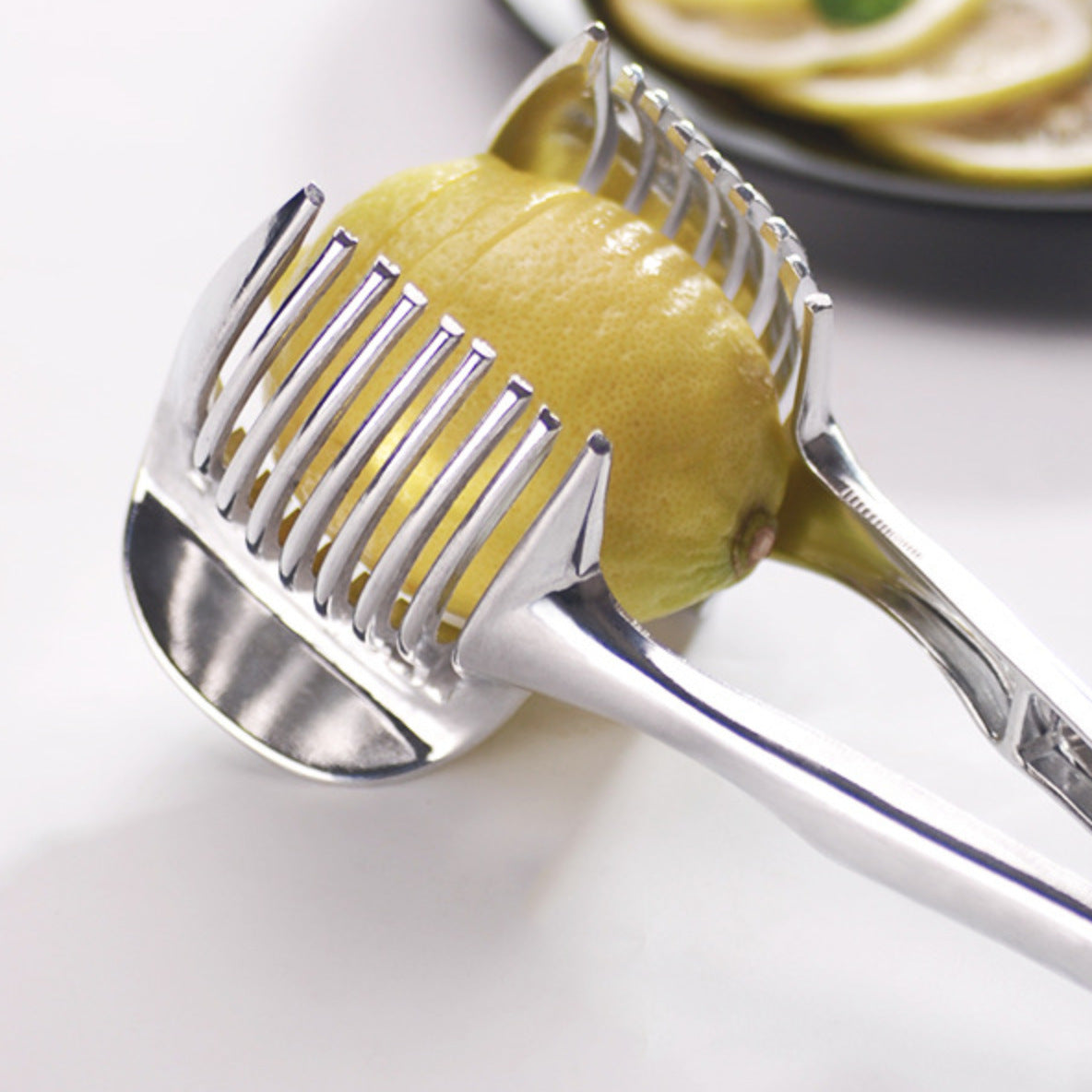 Close-up of a lemon held in the slicing guide tines