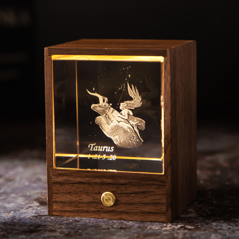 Lit Taurus crystal night light with engraved figure and constellation in a walnut base