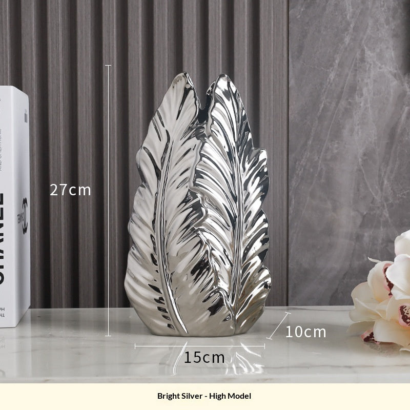Tall bright silver leaf vase shown 27 cm high with a 15 × 10 cm base