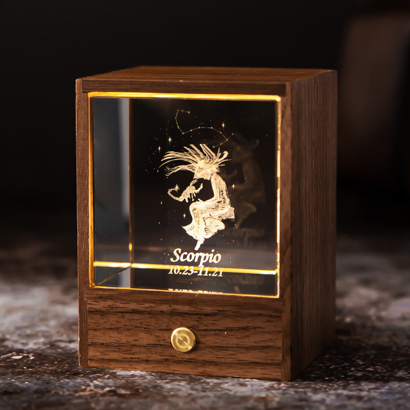 Lit Scorpio crystal night light with engraved figure and constellation in a walnut base