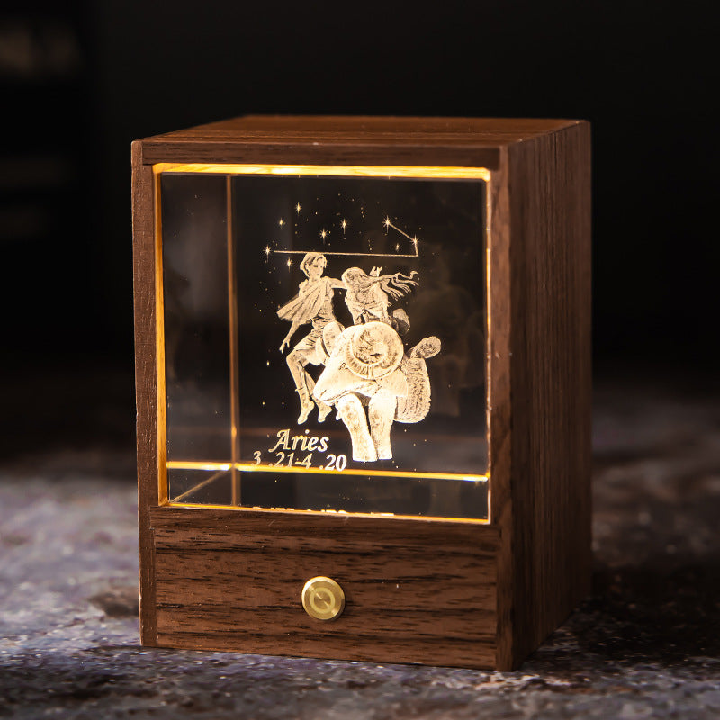 Lit Aries crystal night light with engraved figure and constellation in a walnut base