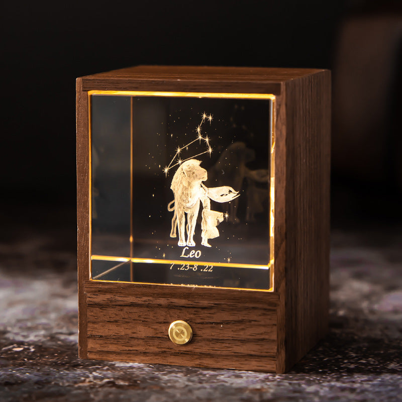 Lit Leo crystal night light with engraved figure and constellation in a walnut base