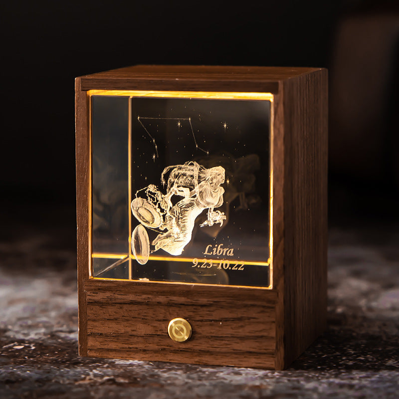 Lit Libra crystal night light with engraved figure and constellation in a walnut base