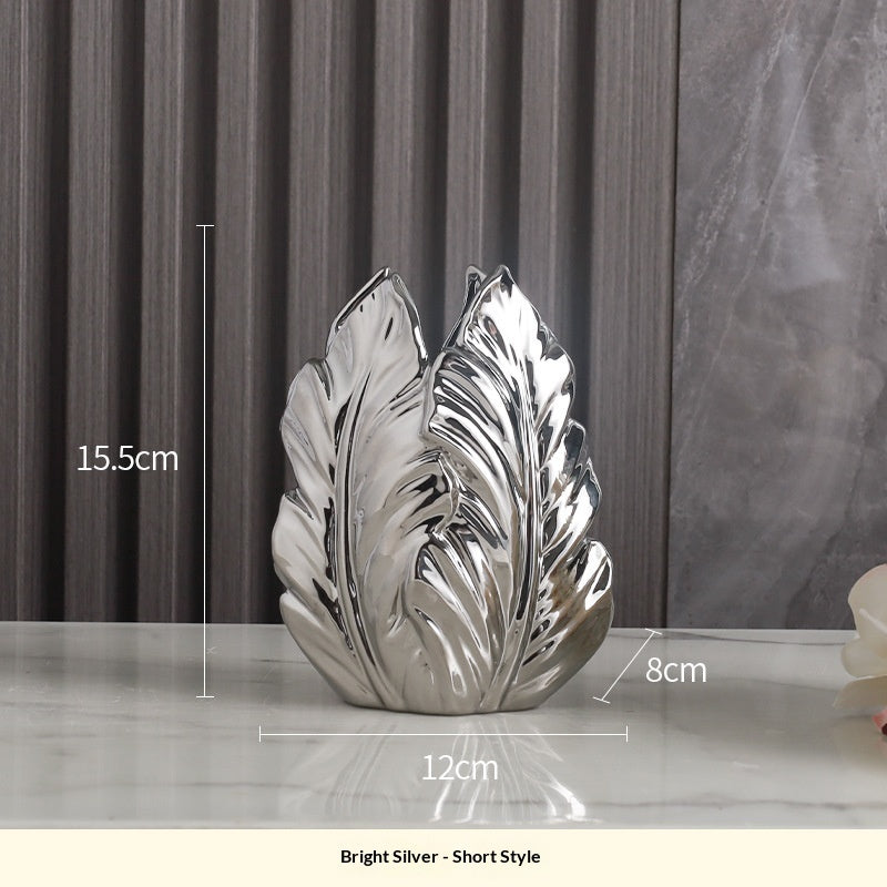Short bright silver leaf vase shown 15.5 cm high with a 12 × 8 cm base