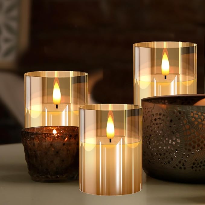 Gold glass flameless candles glowing beside dark metal lanterns